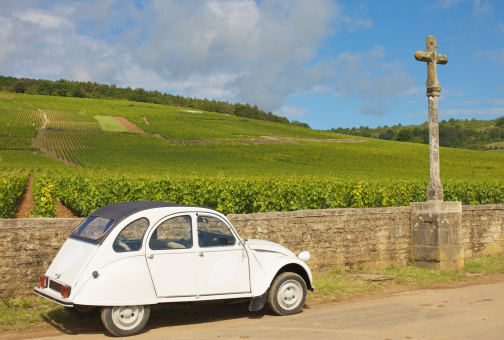 A typical French retro car near a vineyard in Burgundy, France