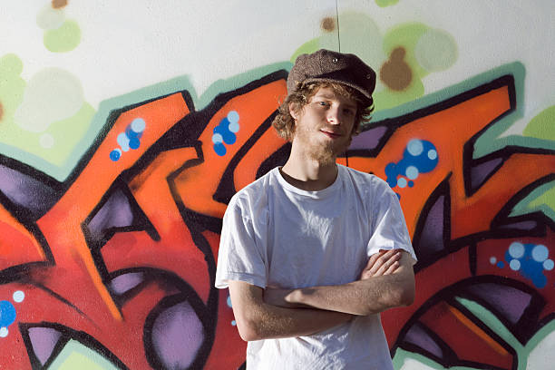 Subject: Portrait of a graffiti artist and his wall.