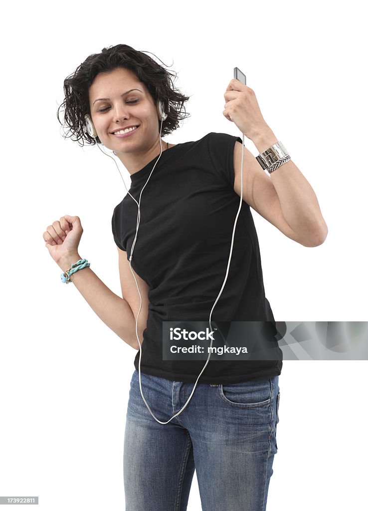 Young Woman Listening Music Young woman listening music and dancing. She's holding a mp3 player. Isolated on white background. 20-29 Years Stock Photo