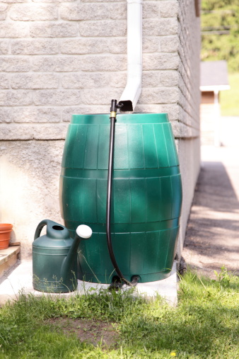 A modern rain barrel used for water conservation. 
