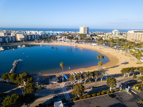 Aerial drone views of the marina in Marina Del Rey, California in the morning light. Views of docked boats, marina beach, marina towers, venice and marina del Rey neighborhoods, the beach, and Los Angeles, CA.