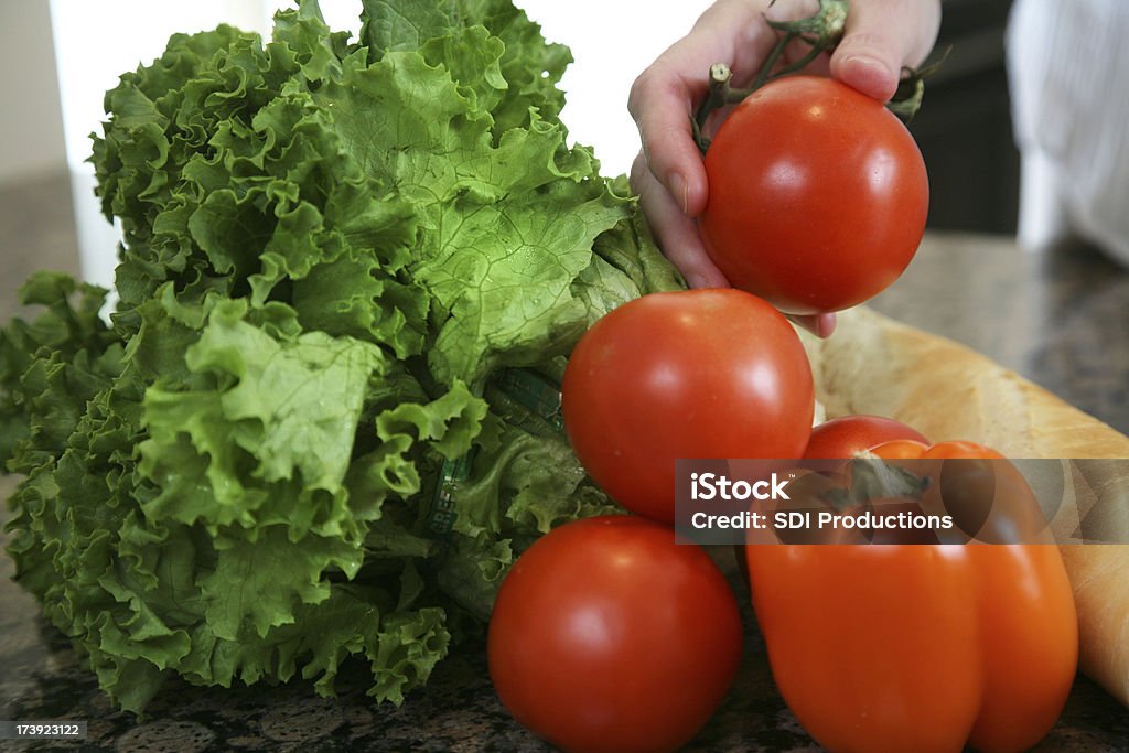 Woman Handling Tomatoes and other fresh food Woman Handling Tomatoes and other fresh vegetables.  Food Stock Photo
