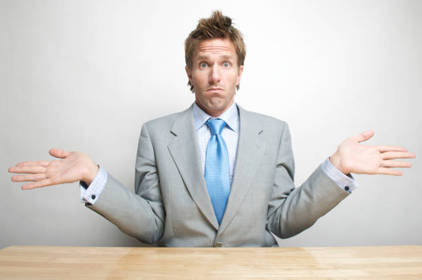 istock Office Worker Businessman Shrugging in Surprise at Desk 173923737