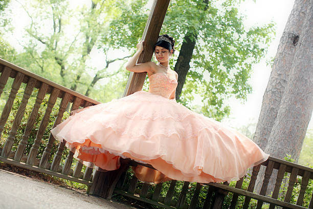 Beautiful Quinceanera Young teen wearing a quinceanera dress on her 15th birthday. quinceanera stock pictures, royalty-free photos & images