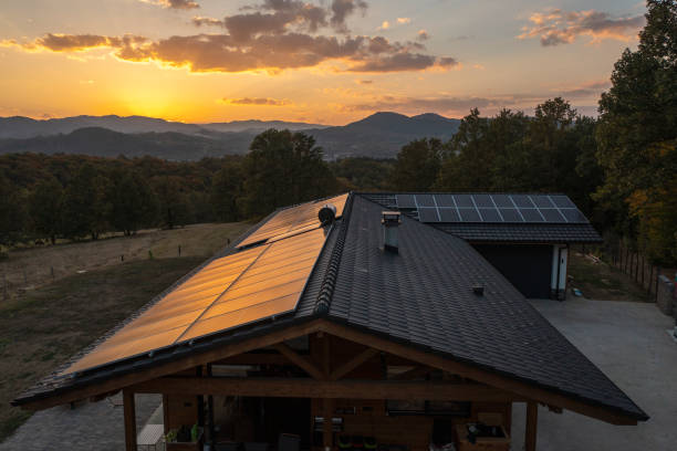 Aerial view of solar powered house in nature shot at sunset.