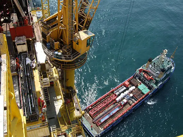 Unloading/Loading an oilfield supply vessel at an oilrigMore offshore rig images: