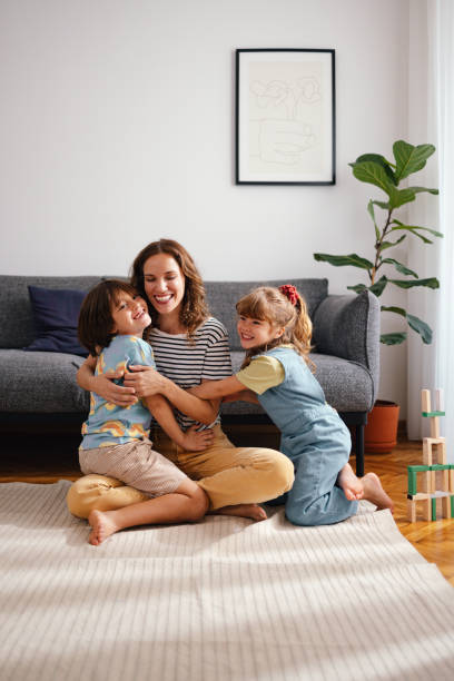 istock A Happy Beautiful Woman Keeping Her Eyes Closed While Enjoying Spending Her Leisure Time At Home With Her Cute Children 1739247048