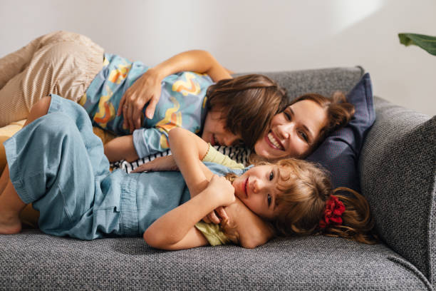 istock A Happy Beautiful Woman Looking At Camera While Enjoying Spending Her Leisure Time At Home With Her Cute Children 1739247066