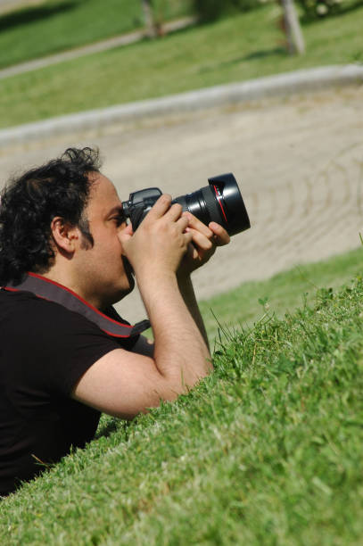 istock photographer on green grass 173924738