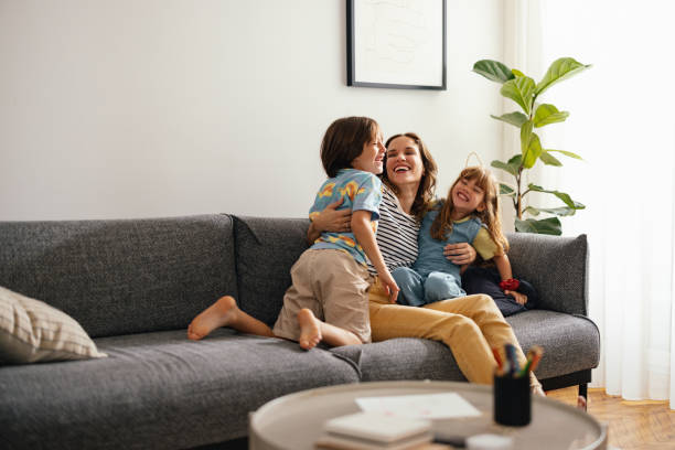 istock A Happy Beautiful Woman Keeping Her Eyes Closed While Enjoying Spending Her Leisure Time At Home With Her Cute Children 1739247619