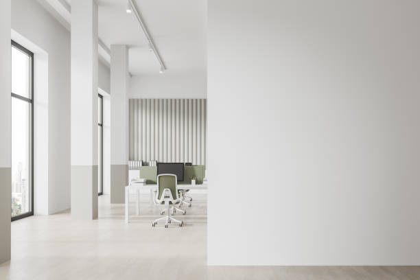 istock White workspace interior with pc monitors and desk near window. Mock up wall 1739247666