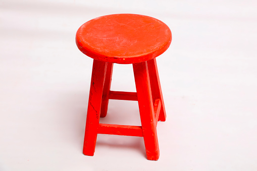 Red colored stool on white background
