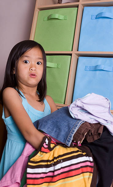 istock Girl making a face while holding heavy laundry 173925988
