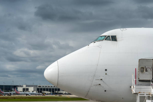 Brussels, Belgium - November 22, 2025: Brussels Airlines Airbus A320 in Star Alliance livery touches down at Brussels Airport with control tower in background.