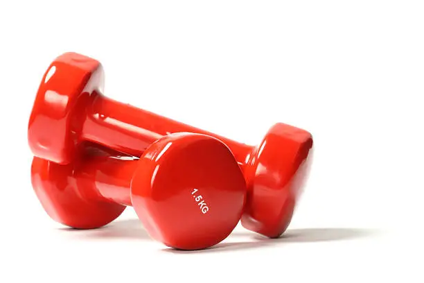 Red dumbbell weights on white background
