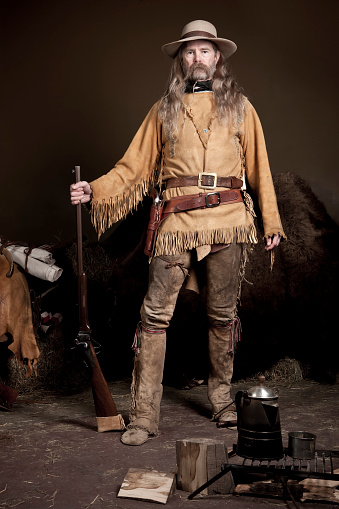 full-body portrait of authentic mountain man in period clothing