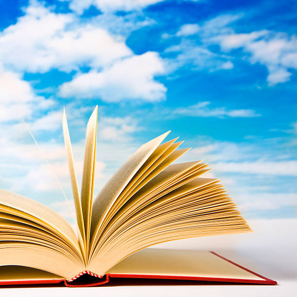 istock Open book laying out with a beautiful sky background 173926834