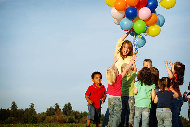 istock Excited Children Reaching for Balloons 173928631