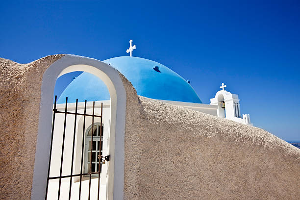 istock Famous Orthodox church with blue dome on Santorini 173929523