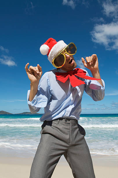 istock Santa Businessman Parties on the Beach 173930286