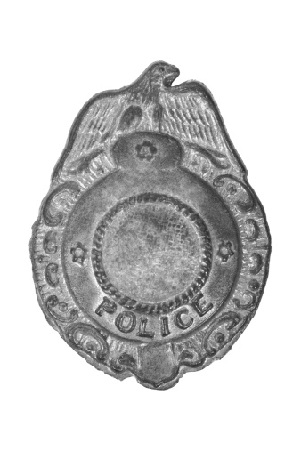 Old police badge on a white background.
