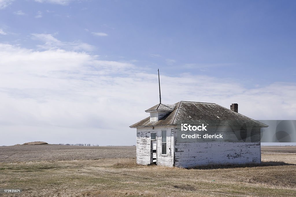 defunct one room country school building defunct one room country school building under big sky on desolate prairie.  Location: North Dakota, USA Run-Down Stock Photo