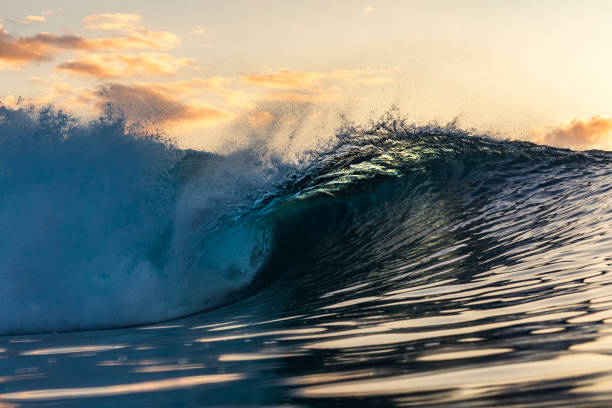 istock Wave breaking in the ocean with golden light 1739326681