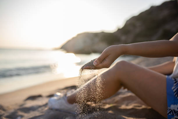 istock Hands playing with sand stock photo 1739330553