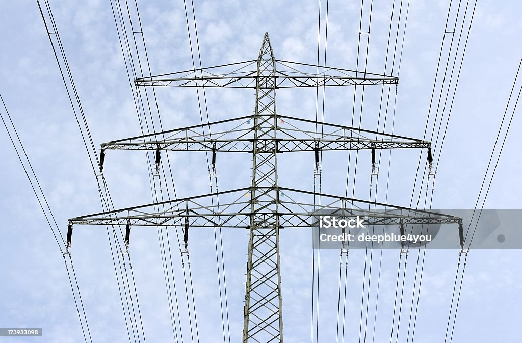 High voltage tower close up of a high voltage tower against blue sky with slightly clouds Abstract Stock Photo