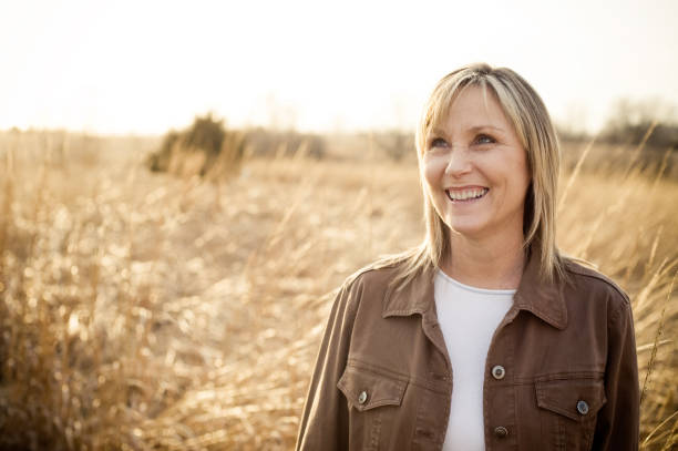 istock Happy Middle-Aged Woman in Field 173933177