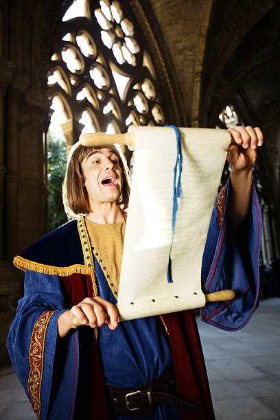 Town Crier Town Crier reading through a scroll in a medieval cathedral town criers stock pictures, royalty-free photos & images
