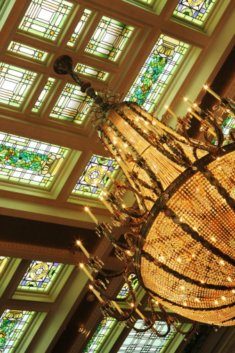 Stained glass ceiling and ornate chandelier.