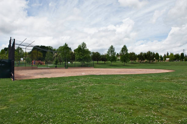 istock Empty neighborhood baseball park under cloudy sky. 173933546