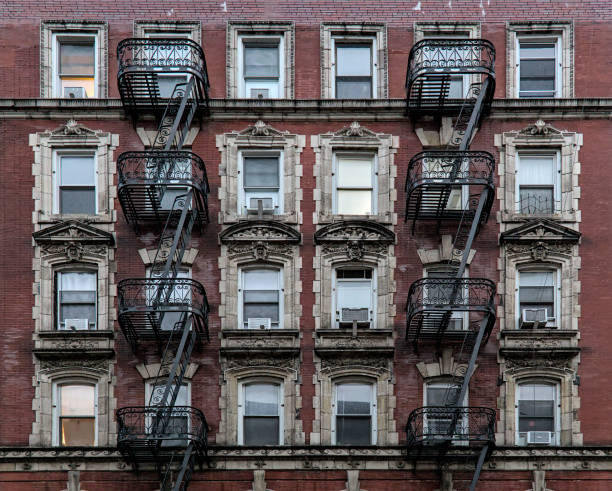 istock typical lower east side apartment building (tenement with fire escape, windows, lamp post) detail (red brick) 1739339437