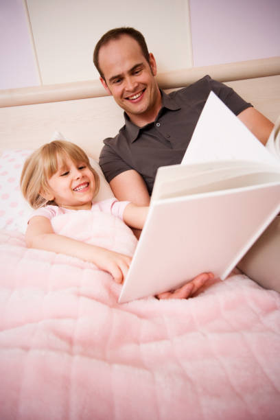 istock Child and Father Reading Book Before Bedtime 173933989