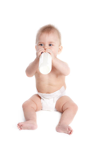istock Baby Wearing Diaper and Holding Bottle Isolated on White 173934197