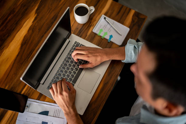 istock Mid adult man working using a laptop at home 1739342302