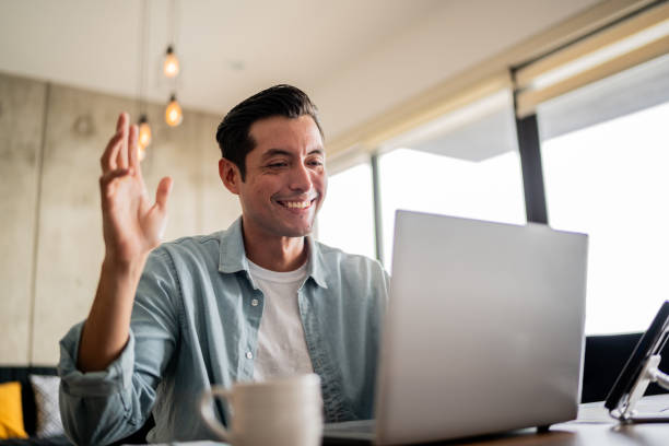 istock Mid adult man talking on video call using a laptop at home 1739342305