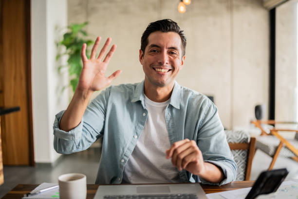 Mid adult man on video call at home