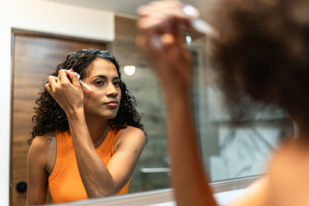 Young woman cleaning her face in the bathroom at home