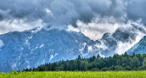 Stormy weather system passing over the Tennengebirge range in the Austrian Alps. High dynamic range photo. Shallow DOF, with main focus on mountains.