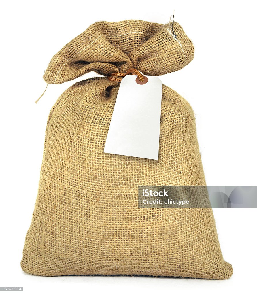 Bag and Label Full bag with a blank tag. Insert your own message. Isolated on white. Canvas Fabric Stock Photo