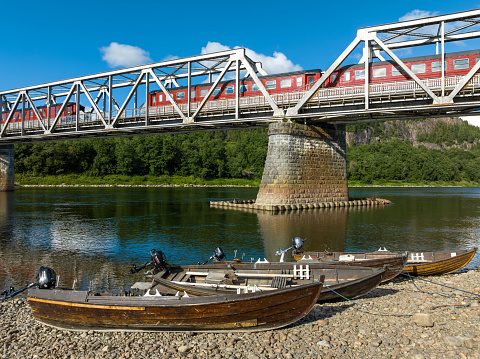 railroad bridge with 4 permanently parked train wagons over the Namsen river in Norway.