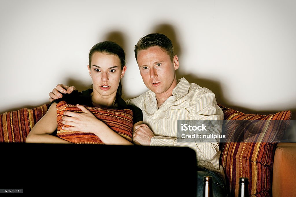 Coppia di guardare la TV - Foto stock royalty-free di Abbracciare una persona