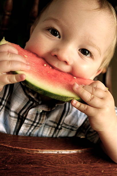 istock Baby Eating Watermelon 173935878