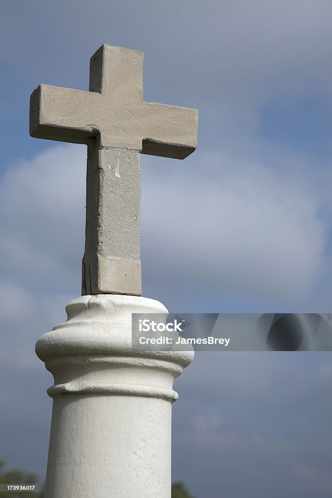 Tall Grave Marker With Stone Cross "In a cemetery near my home I found this tall grave marker with a stone or concrete cross. It is a powerful symbol of religious faith, death, and our limited time here on earth. I placed it on the left with copy space at right." Cemetery Stock Photo