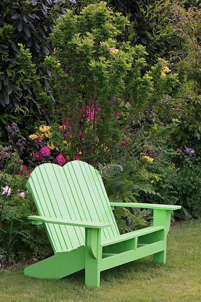istock Lush Garden With Green Adirondack Chair 173936190