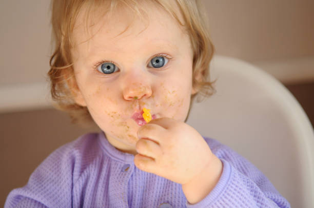istock Messy Little Baby Eating Food 173936292