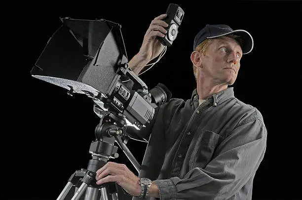 Filmmaker with lightmeter isolated on blackCareers
