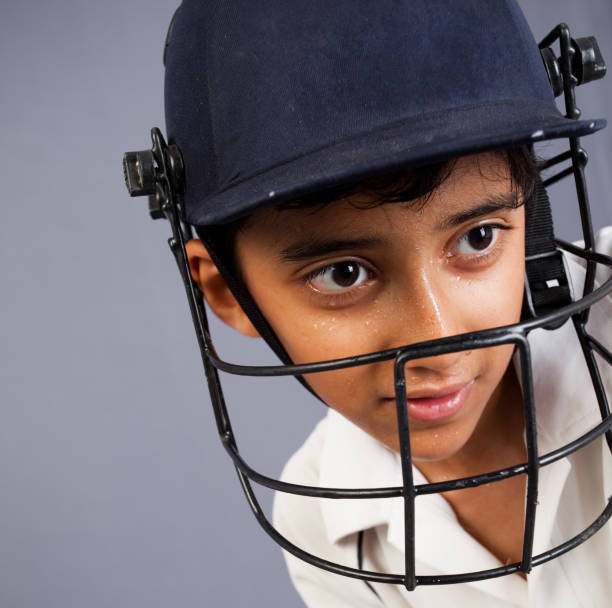 Indian boy sports person player wearing cricket helmet Indian boy wearing cricket helmet indian boy playing cricket stock pictures, royalty-free photos & images